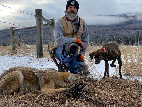 Image of Paul Antczak with a wolf he trapped