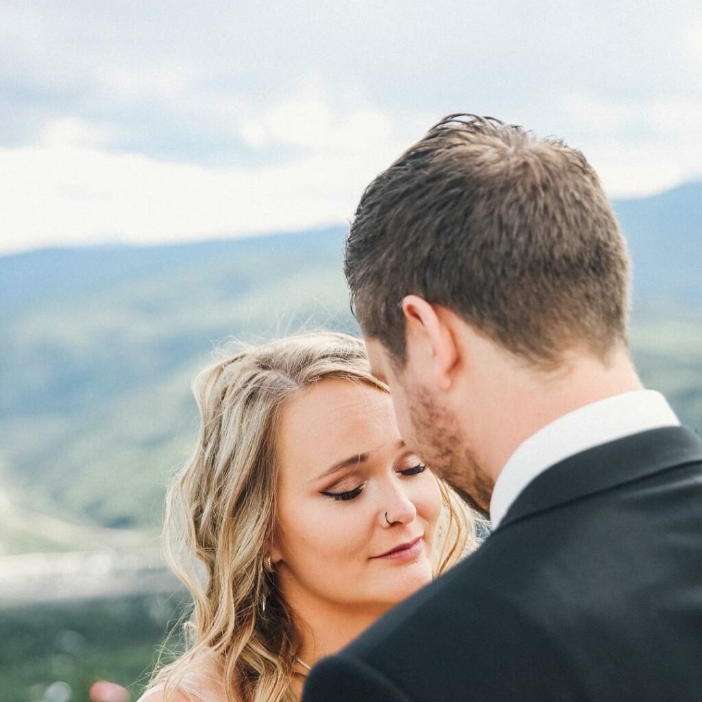 Image of Monica Beets on her wedding, wearing a wedding dress holding her husband Tyler's hand