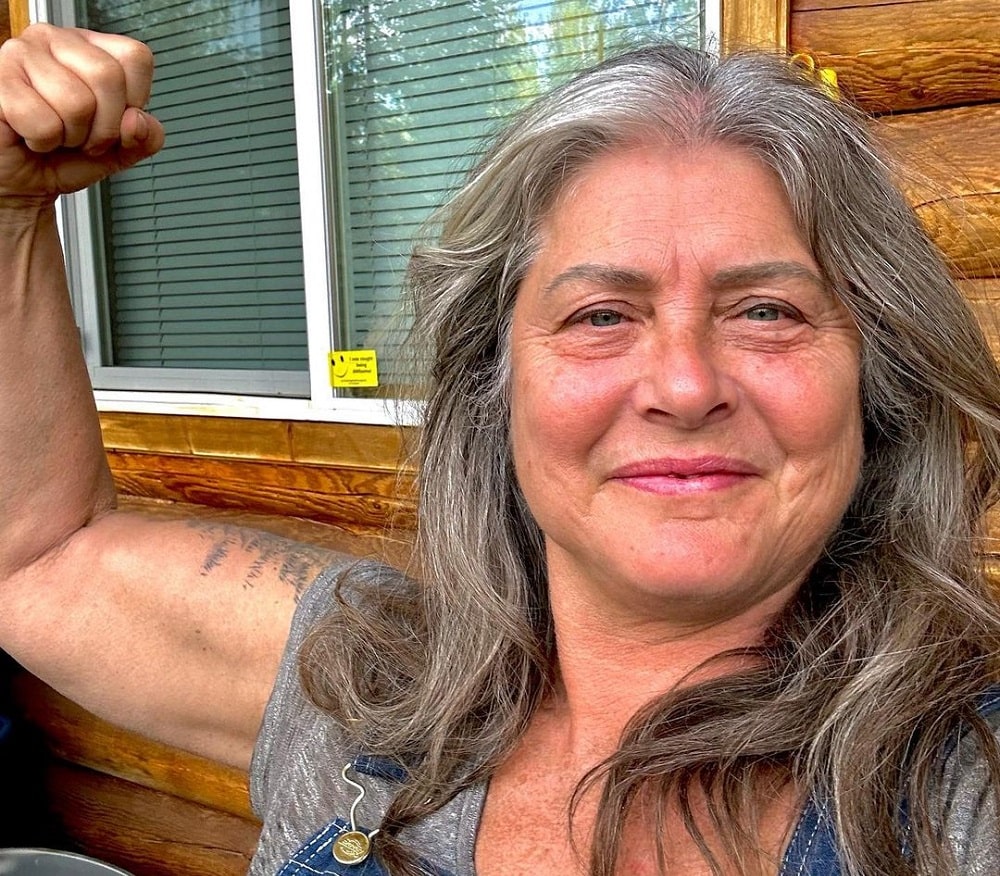 Image of Sue Aikens showing her bicep.